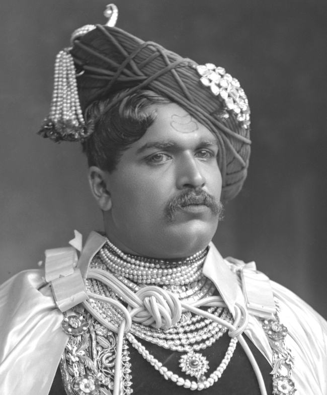 Colonel H.H. Maharaja Shrimant Sir Shahu Bhonsle Chhatrapati Bahadur, Maharaja of Kolhapur, GCSI (1.1.1895), GCIE (12.12.1911), GCVO (1.1.1903). b. at The Circuit House, Kolhapur, 26th July 1874, eldest son of H.H. Meherban Shrimant Chiranjiva Rajashri Jaisinh Rao alias Abba Sahib Ghatge, Sarjerao Vazarat, Ma-ab, 4th Chief of Kagal (Senior), by his first wife, Shrimant Akhand Soubhagyavati Radha Bai alias Baba Sahib Maharaj, only daughter of Meherban Shrimant Balwantrao Venkatrao Raje Ghorpade, Chief of Mudhol. Educ. Rajaram Coll., Kolhapur and Rajkumar Coll., Rajkot. Adopted by H.H Rani Anand Bai Sahib, widow of H.H. Raja Shivaji IV, 17th March 1884 and ascended the gadi on the same day. Reigned under the Regency of his father until 20th March 1885 and thence under a Council of Regency until he came of age. Invested with full ruling powers, 2nd April 1894.